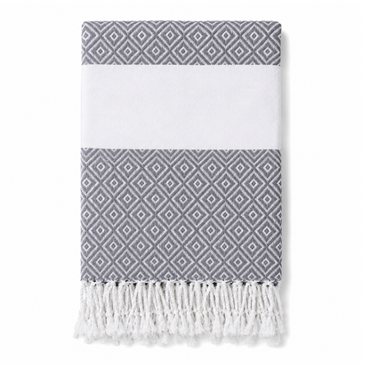 Folded gray geometric stripe towel with white tassels