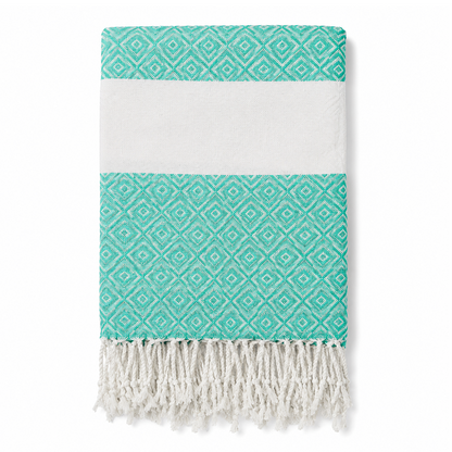 Folded turquoise geometric stripe towel with white tassels