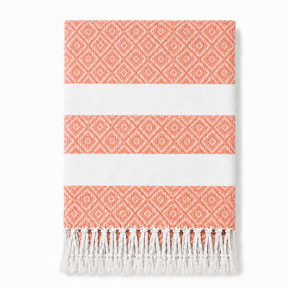 Folded coral geometric stripe towel with white tassels