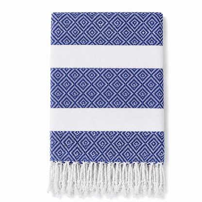 Folded dark blue geometric stripe towel with white tassels