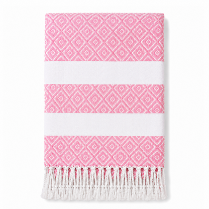 Folded pink geometric stripe towel with white tassels